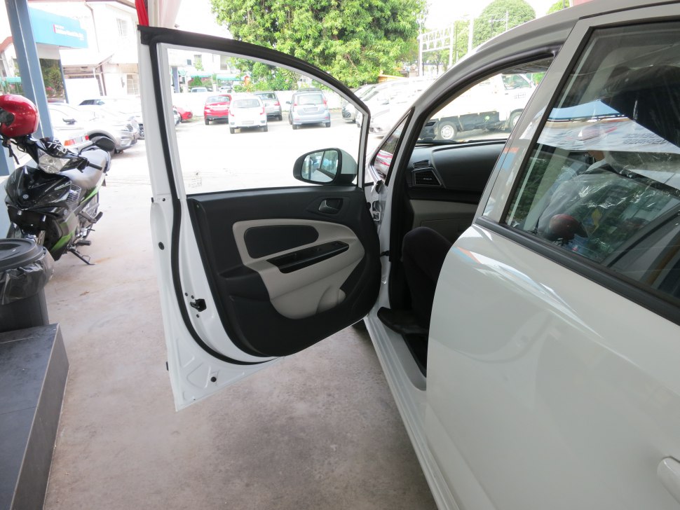 Interior door panel with door handle and window controls.