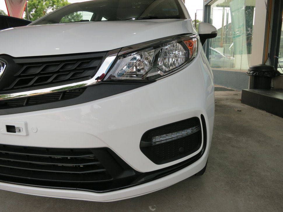 Close-up of front headlight and grille with fog light insert on a car