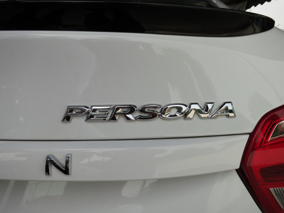 Close-up of rear emblem badge and tail light section