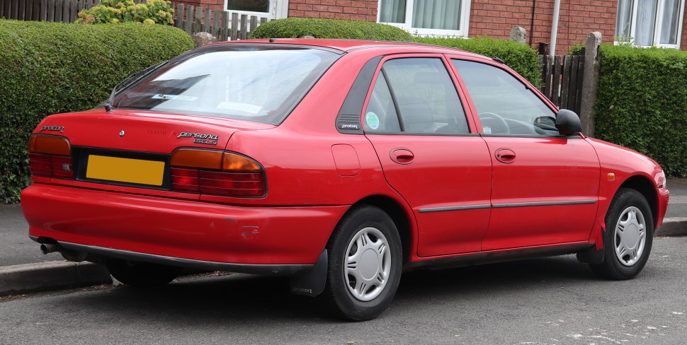 Rear and side view of a classic four-door sedan with distinct tail lights and wheel covers