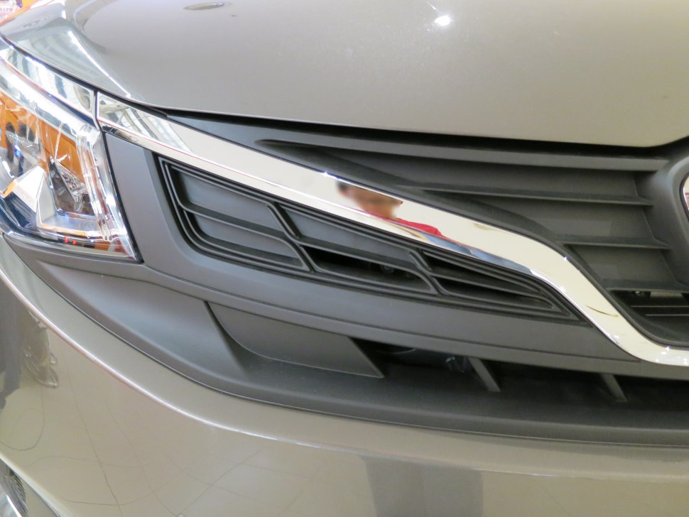 Front grille with chrome accent and headlight assembly close-up