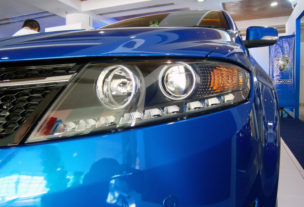 Modern dual projector headlights and front grille with blue paint