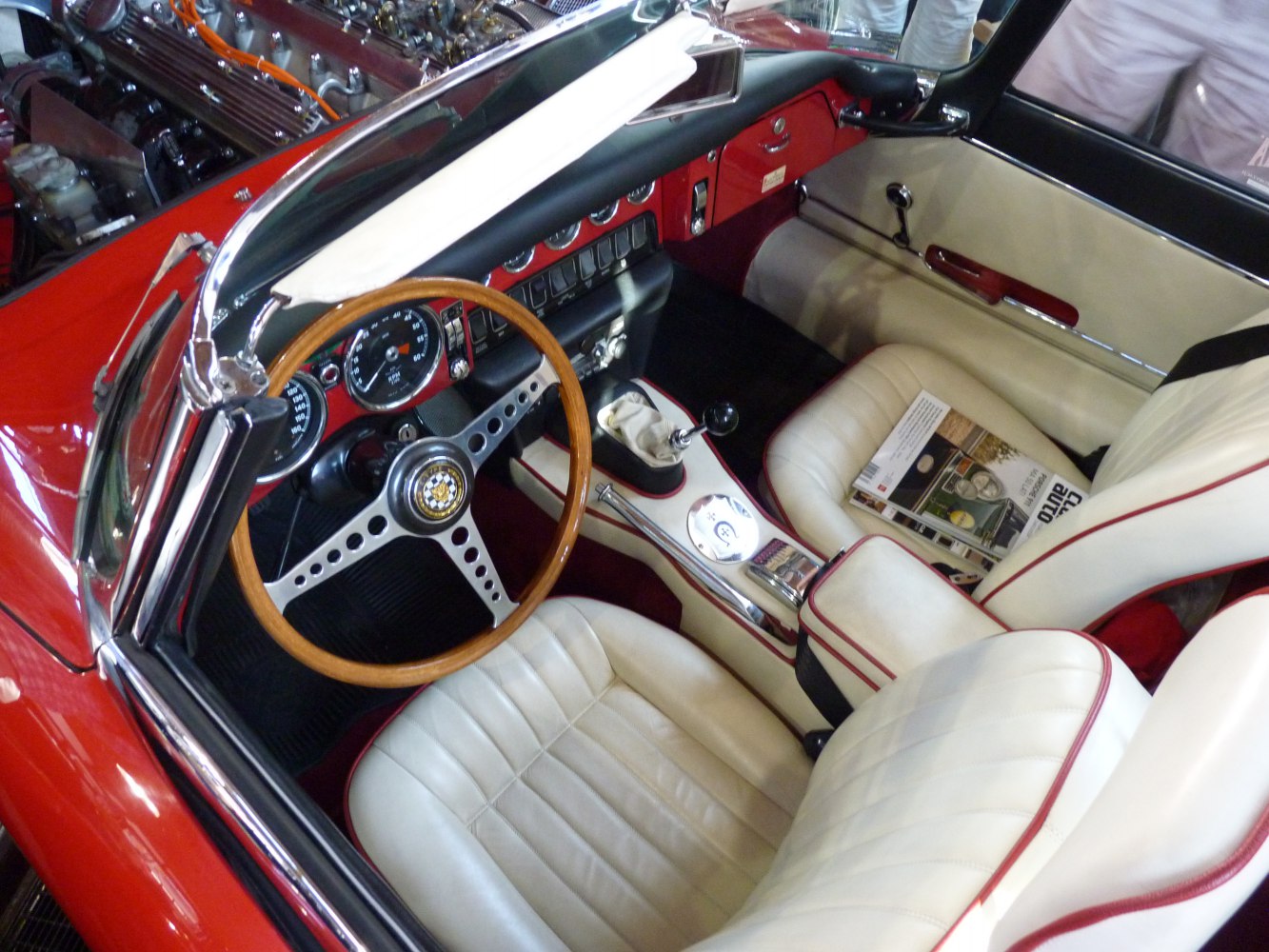 Wooden steering wheel and cream leather seats in a vintage convertible interior