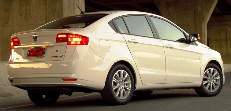 Rear view of sedan with tail lights and alloy wheels