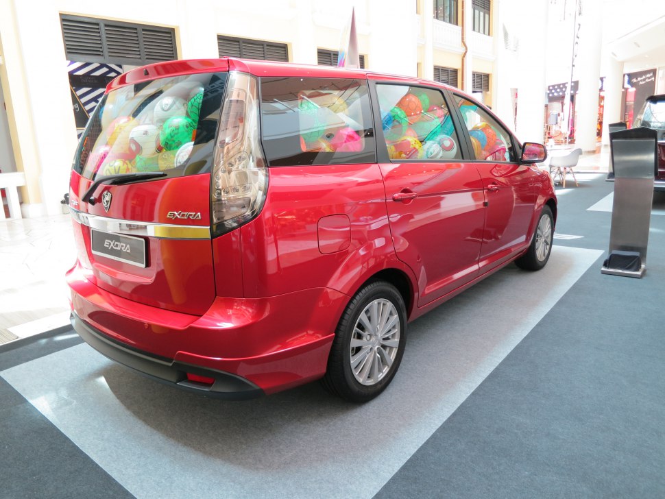 Red MPV rear and side with multi-spoke wheels and clear taillights