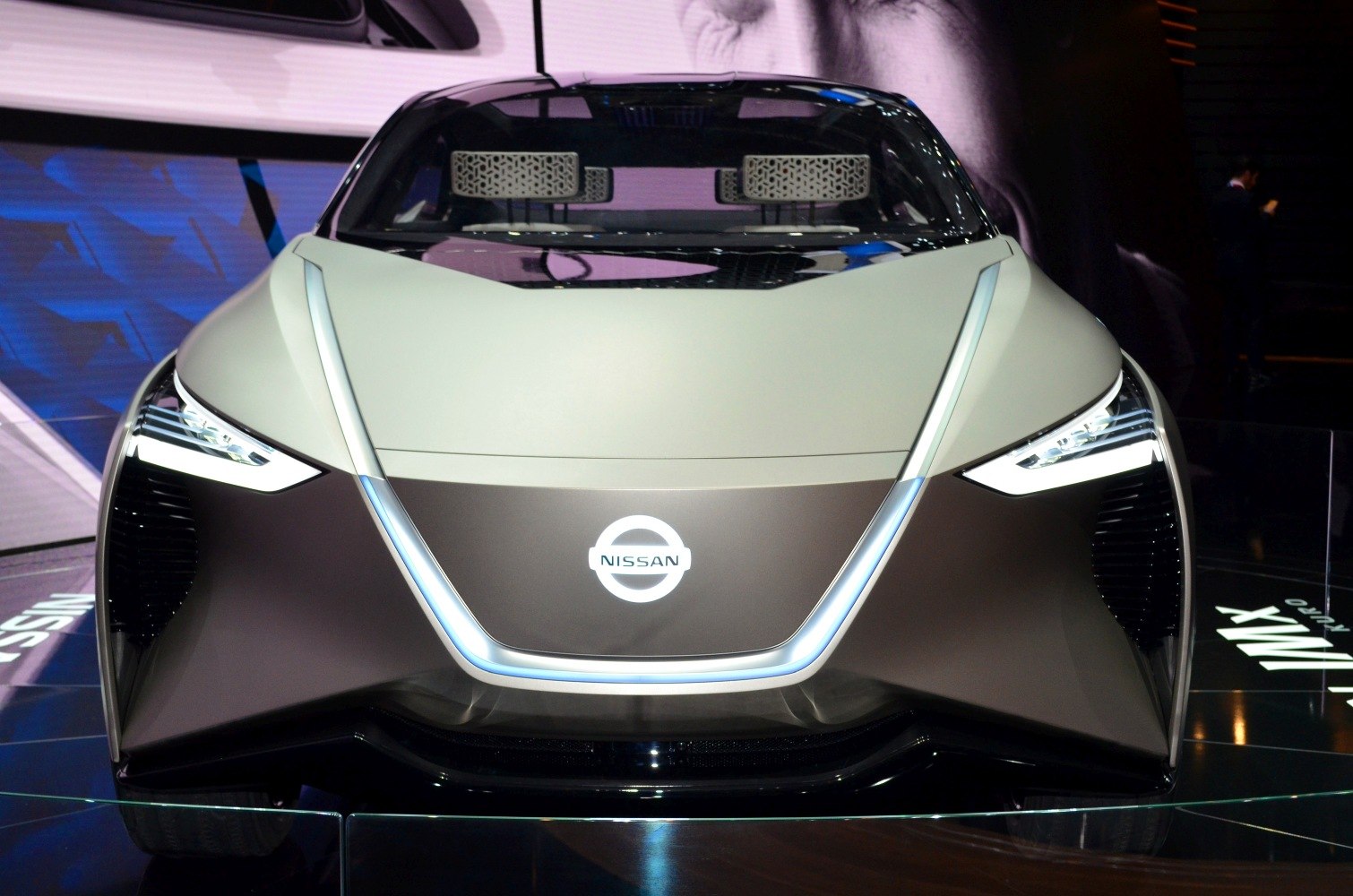 Sharp LED headlights and illuminated V-motion grille on futuristic concept car front.