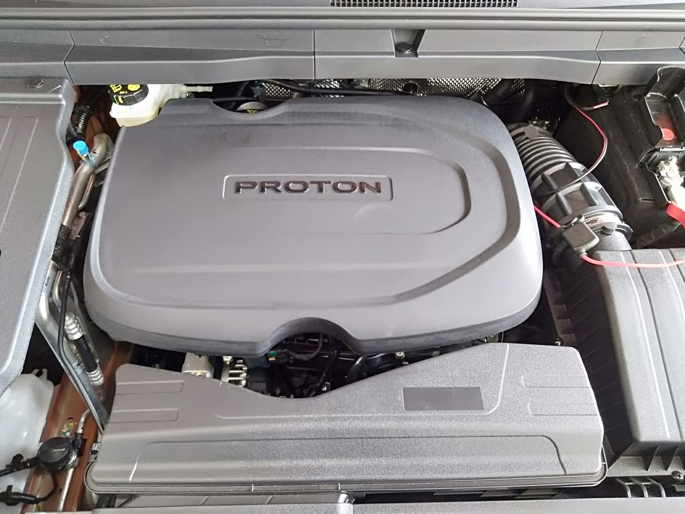 Engine bay with Proton-branded engine cover