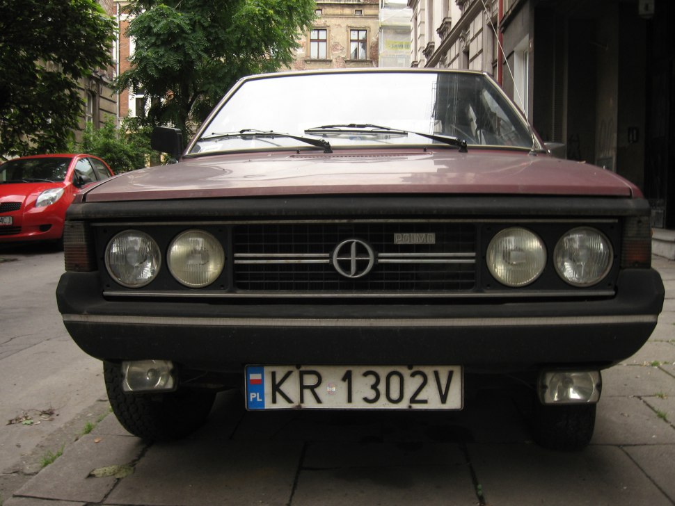 Front view with quad round headlights and vintage grille
