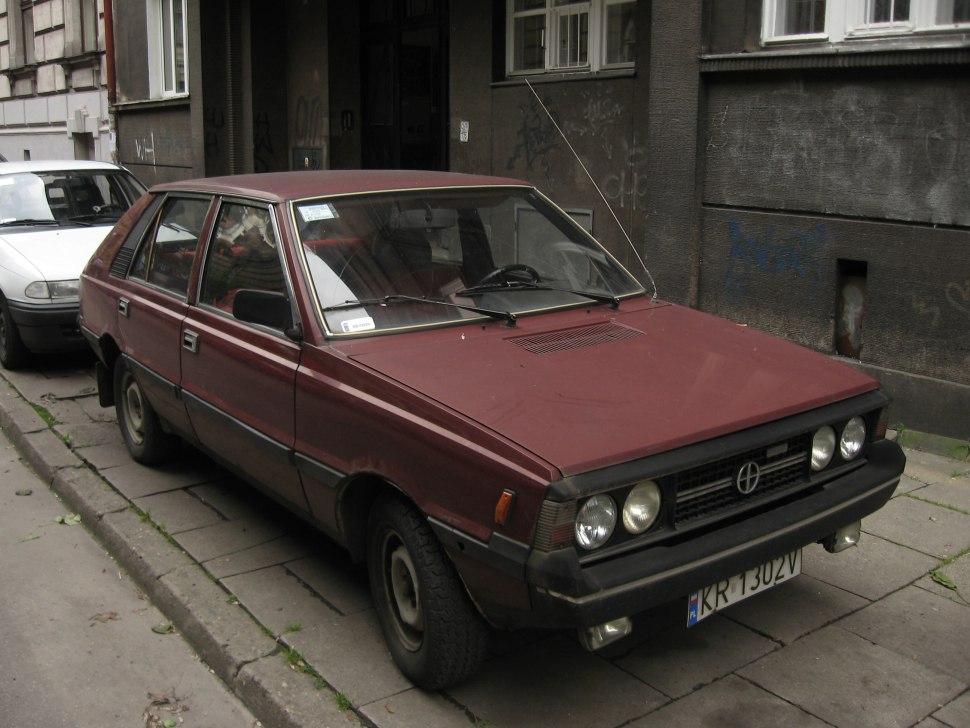 Angular front hatchback with dual round headlights and raised hood vent