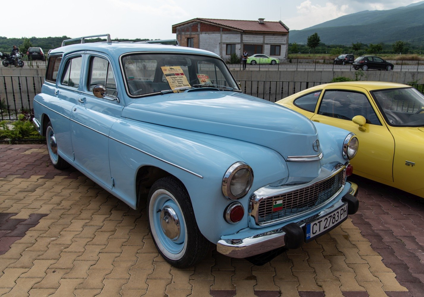 Front and side view of a vintage station wagon with rounded headlights and classic grille.