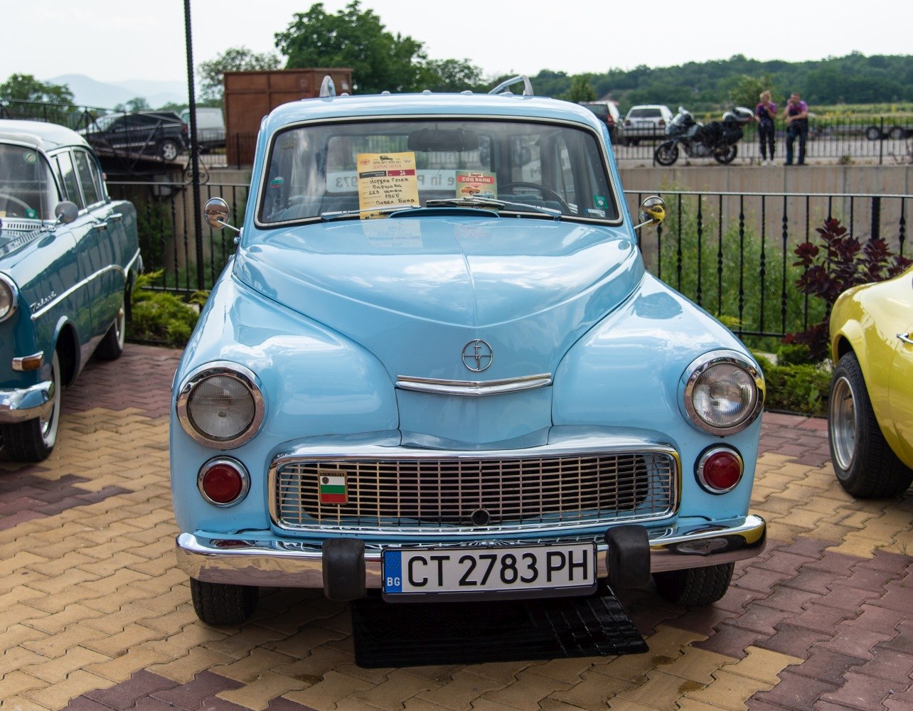Front view of vintage car with rounded headlights and chrome grille
