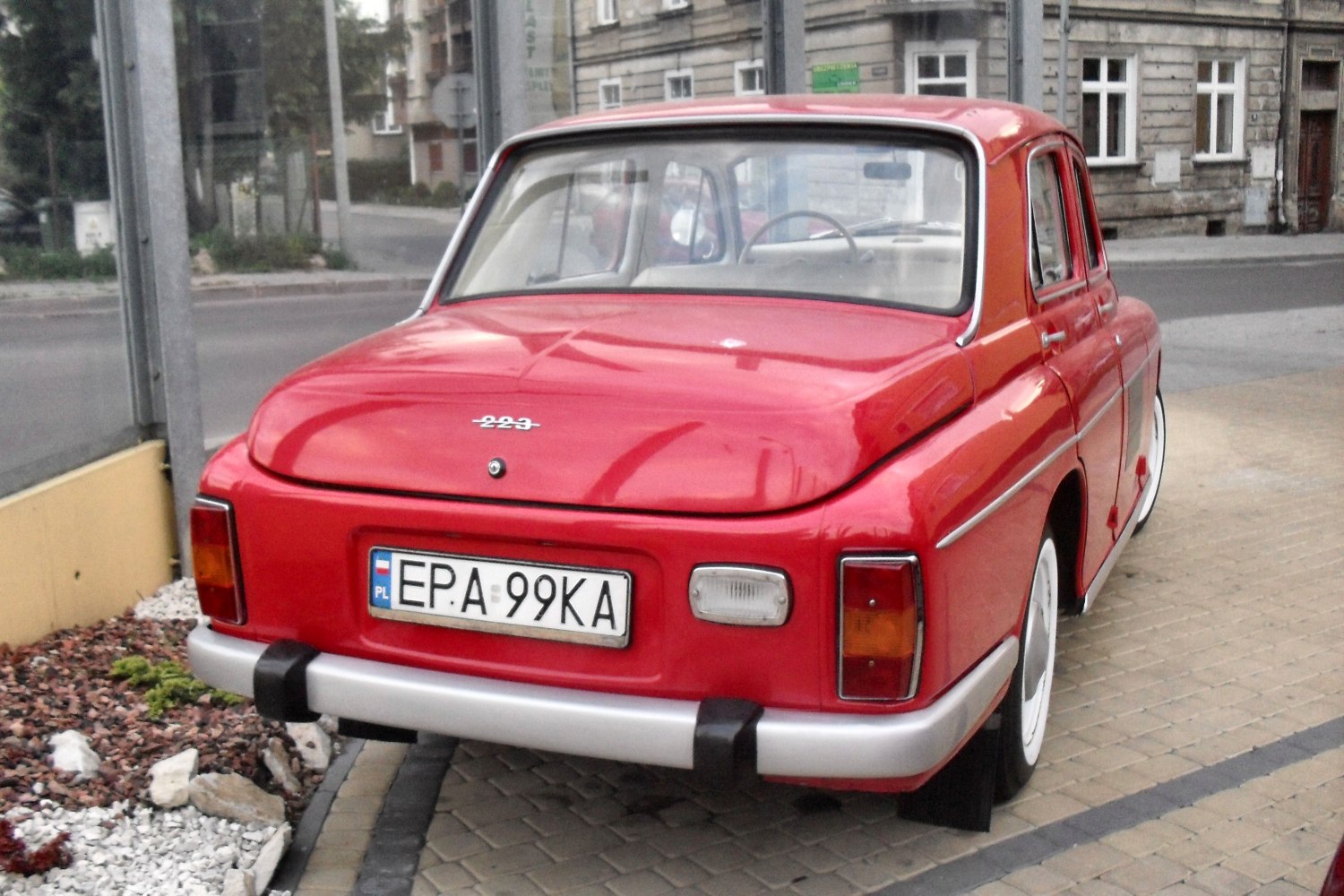 Close-up of vintage car rear with unique tail lights and chrome bumper