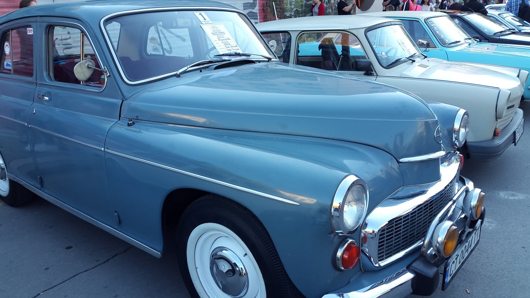 Vintage car front grille with round headlights and chrome bumper