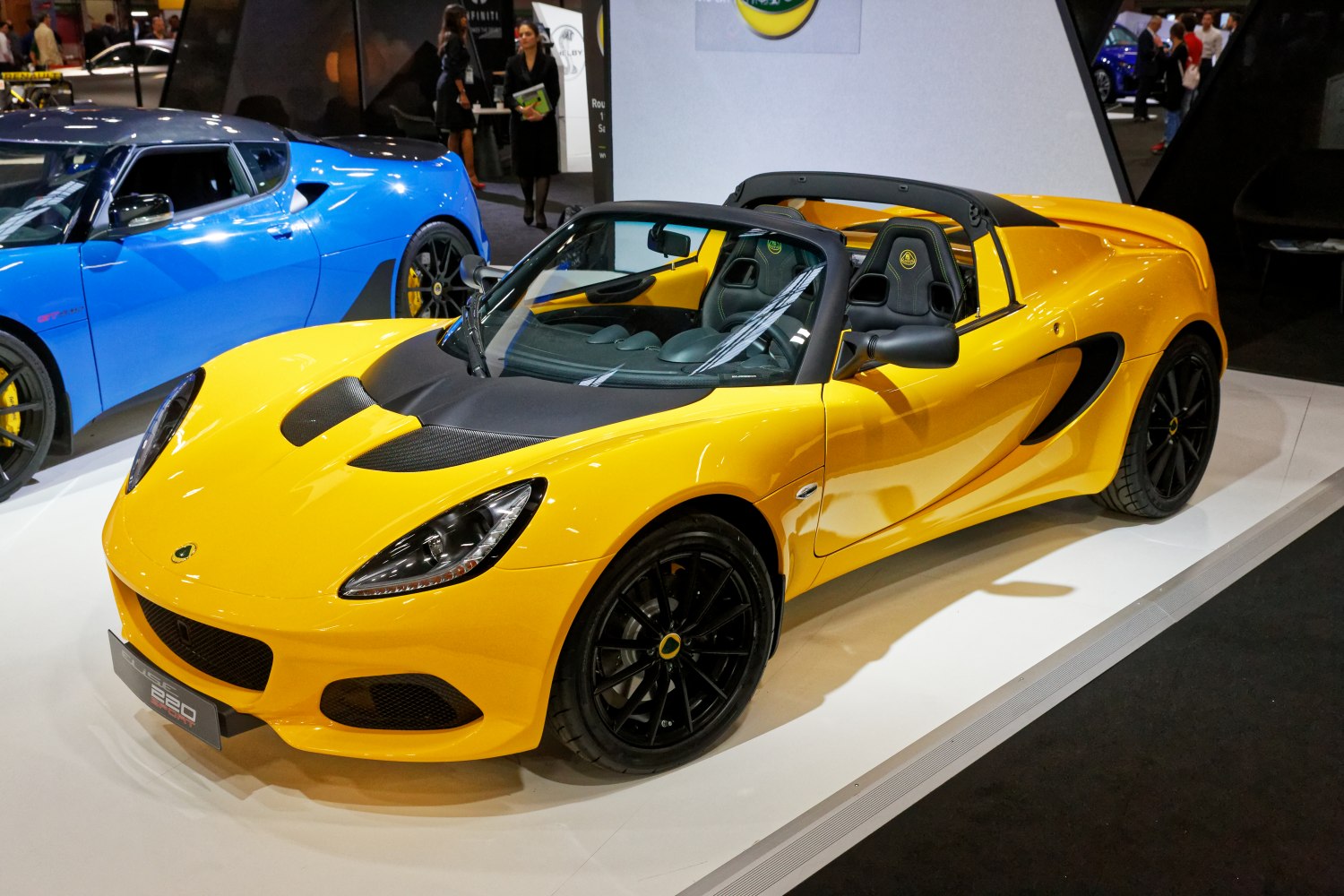 Yellow convertible sports car with black wheels and sporty aerodynamic design