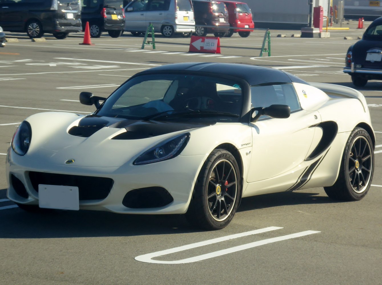 White convertible roadster with sleek front side and sporty wheels.