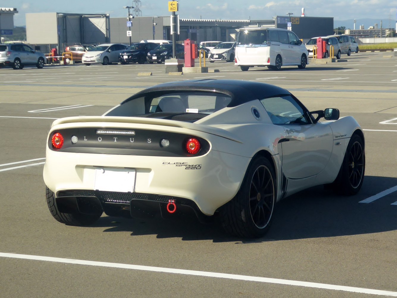 Rear view of sports coupe with circular taillights and integrated spoiler