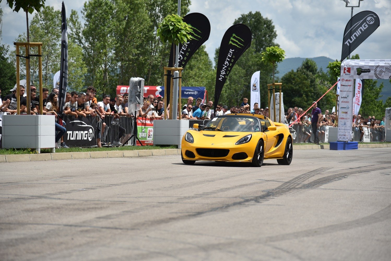 Yellow convertible sports car with aerodynamic vents at event