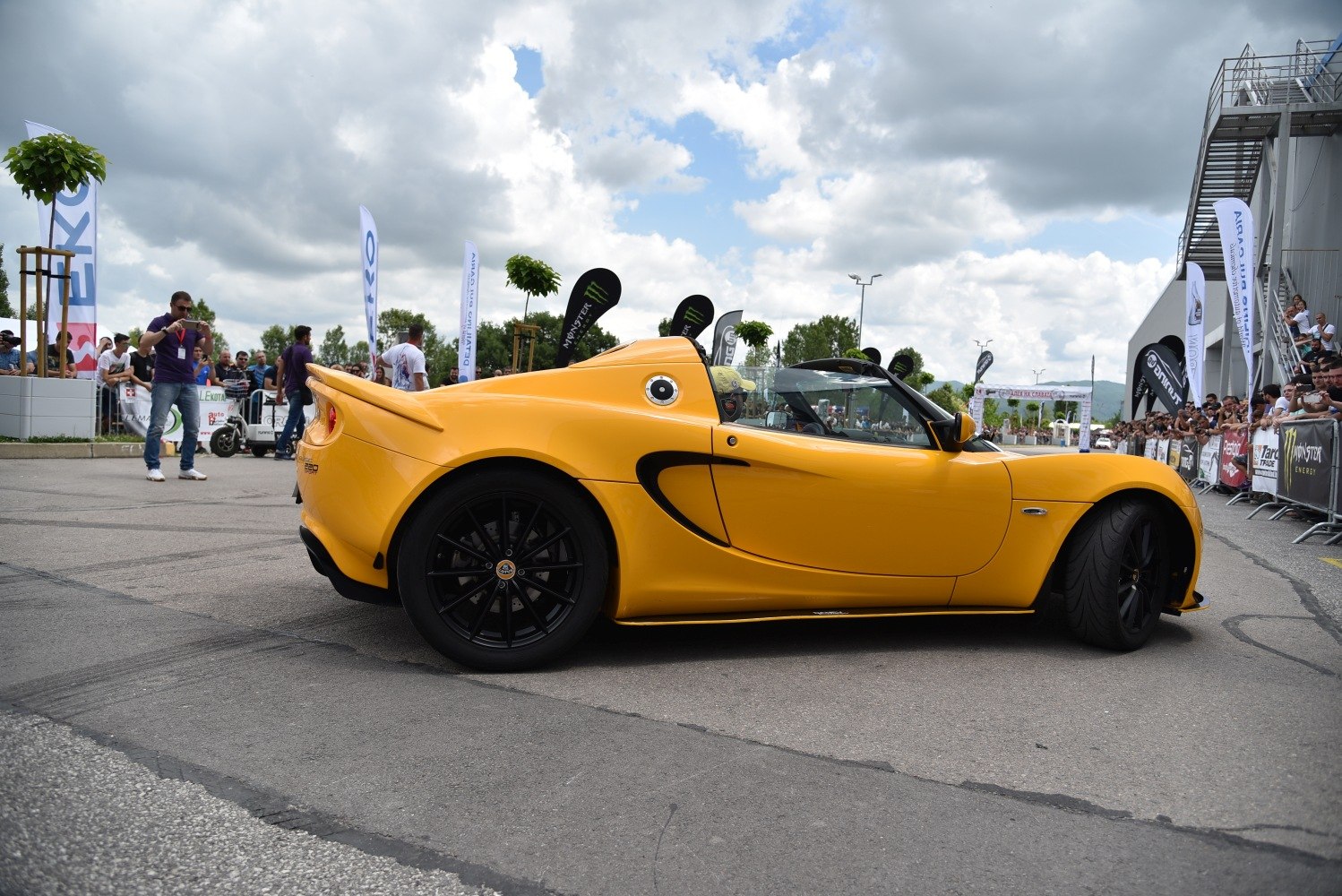 Yellow roadster with black alloy wheels and aerodynamic body shape