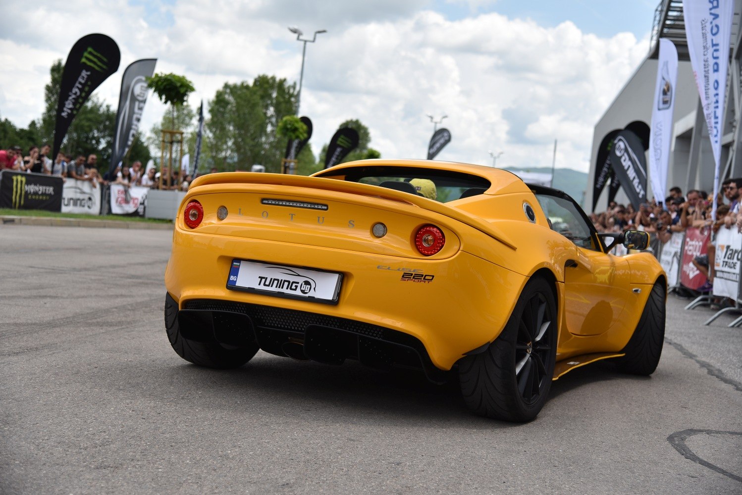 Rear view of yellow Lotus Elise 220 Sport with sleek diffuser and round tail lights