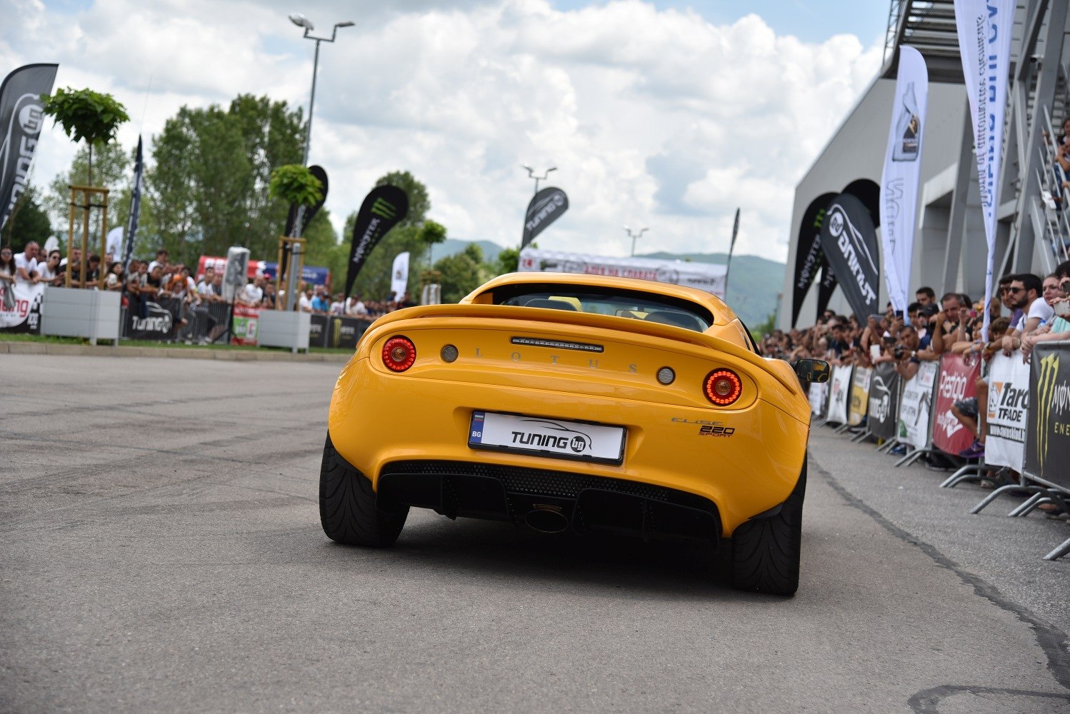 Rear view of yellow Lotus Elise with dual round tail lights and rear diffuser