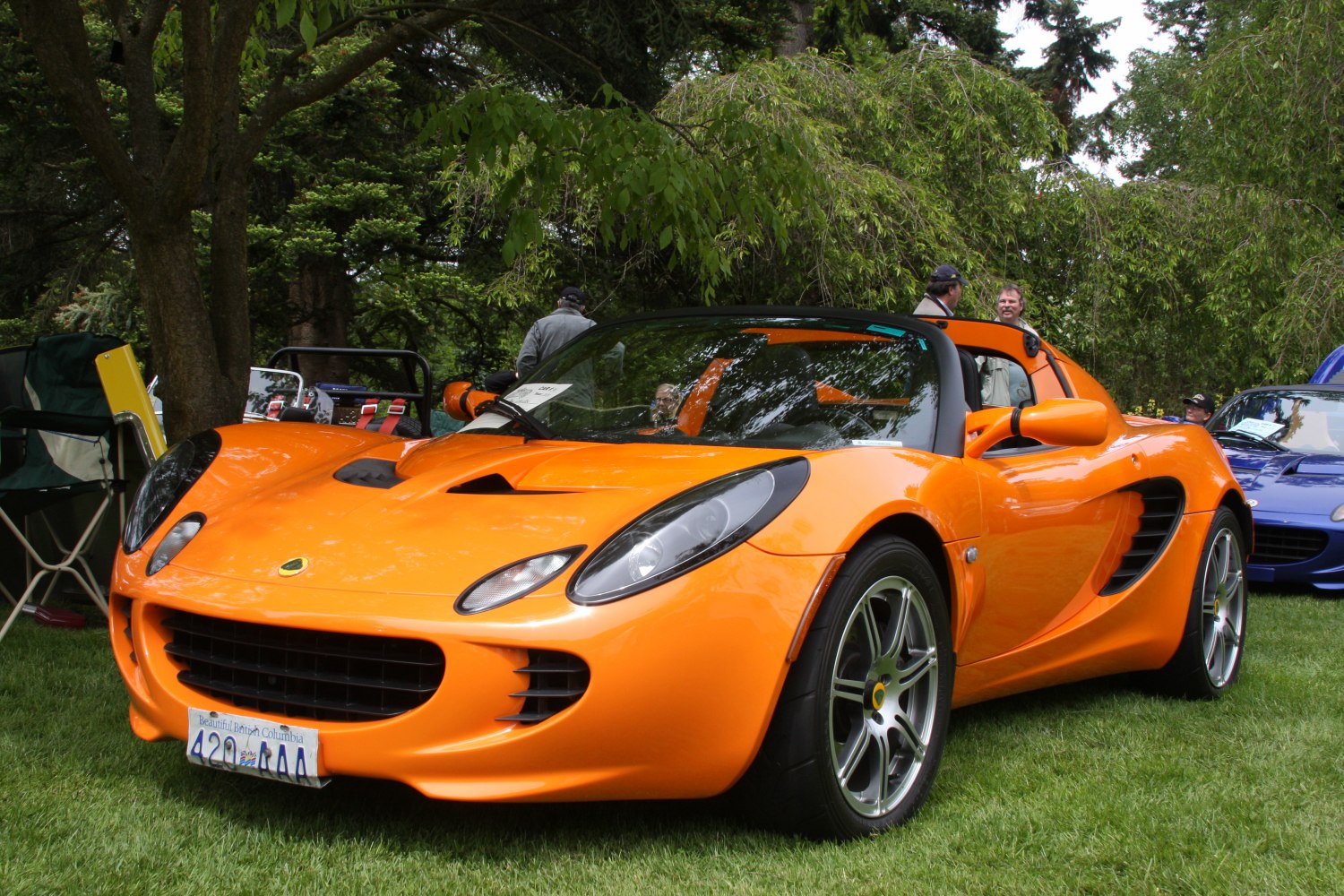 Bright orange sports roadster with aerodynamic vents and sleek headlights