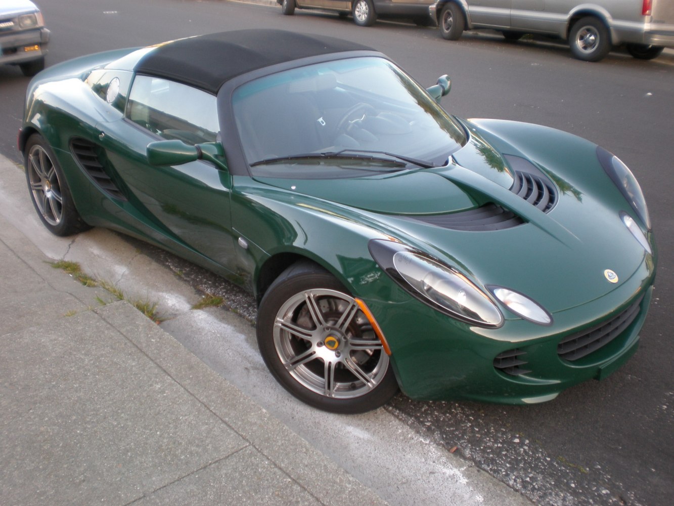 Green lightweight roadster with aerodynamic design and two-door convertible layout