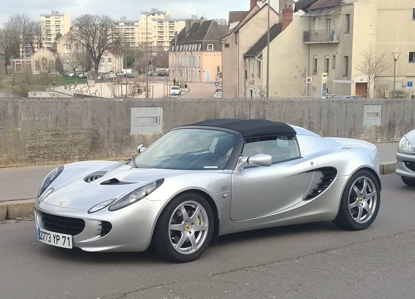 Silver sports convertible with aerodynamic body and side vents