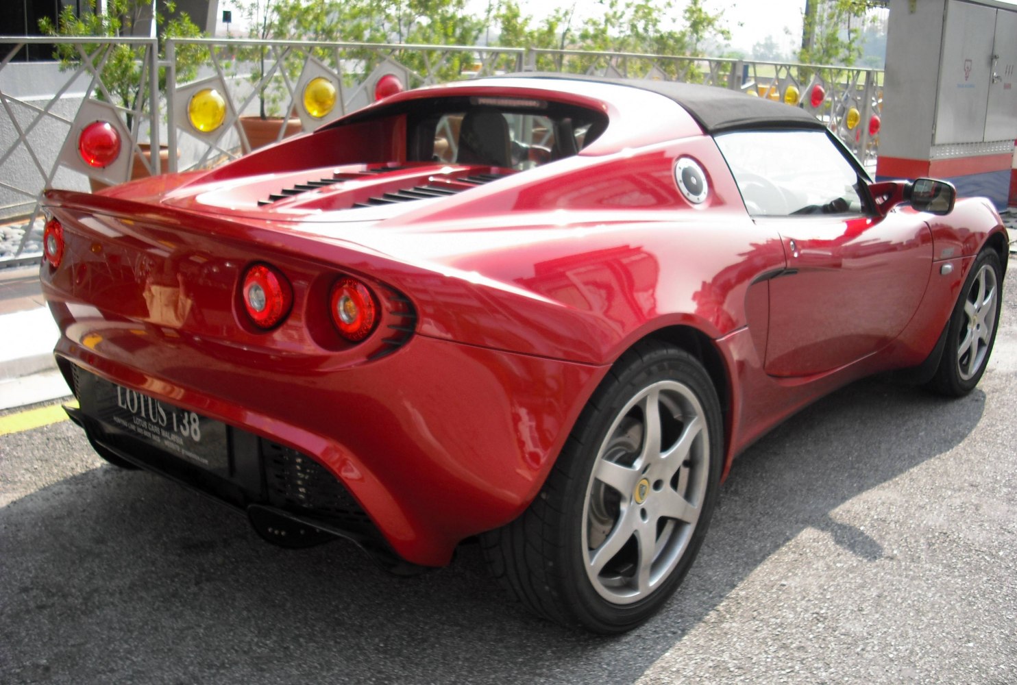Red sports coupe rear with round taillights and aerodynamics