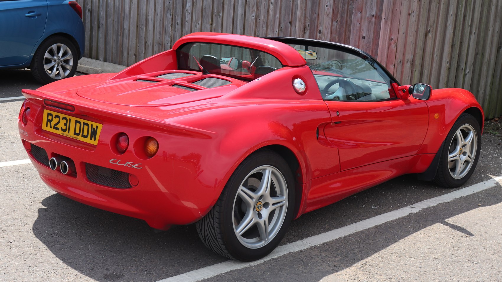 Rear view of a sports roadster featuring distinctive rear wing and dual exhaust setup