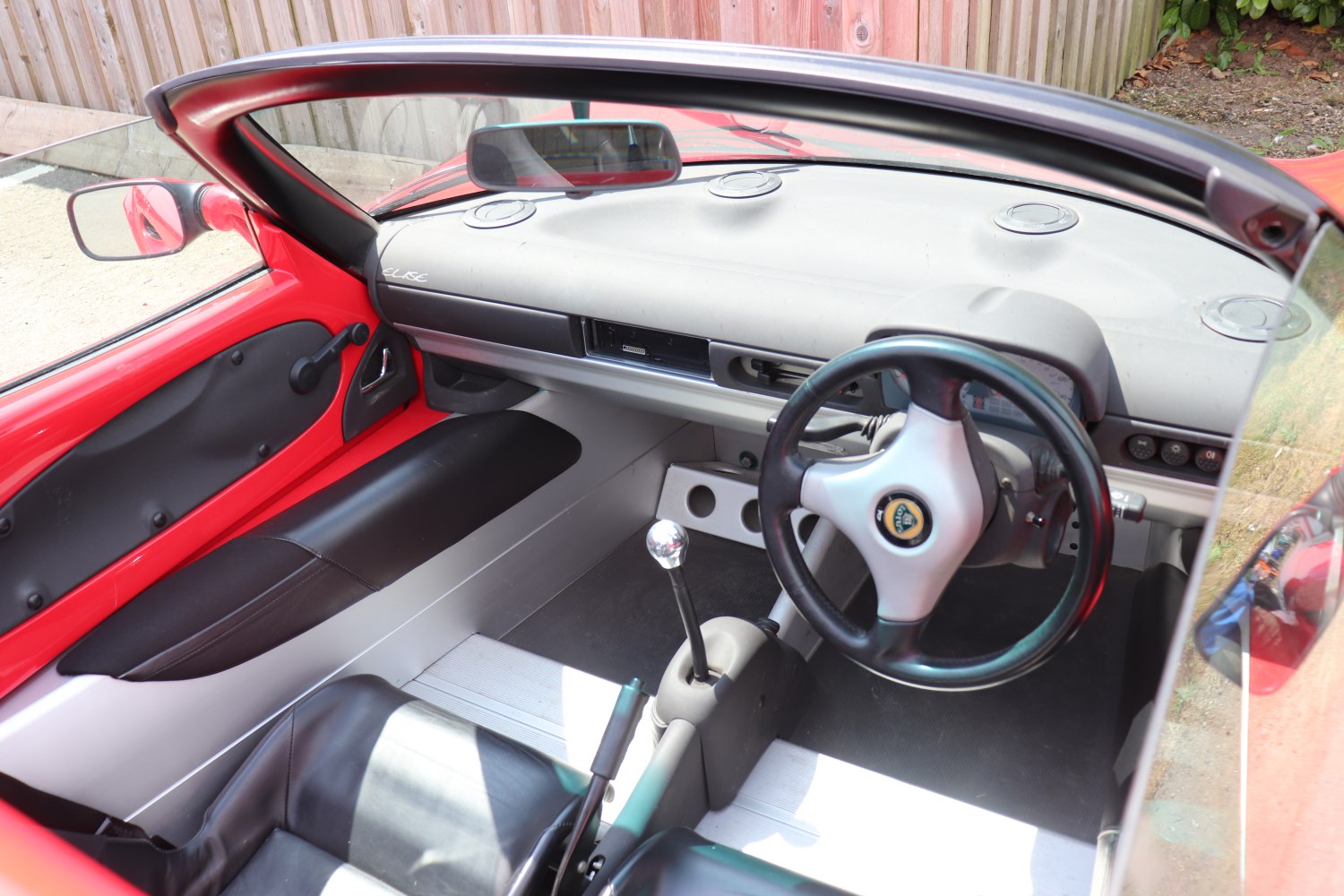Minimalist car interior with steering wheel and manual gear shifter