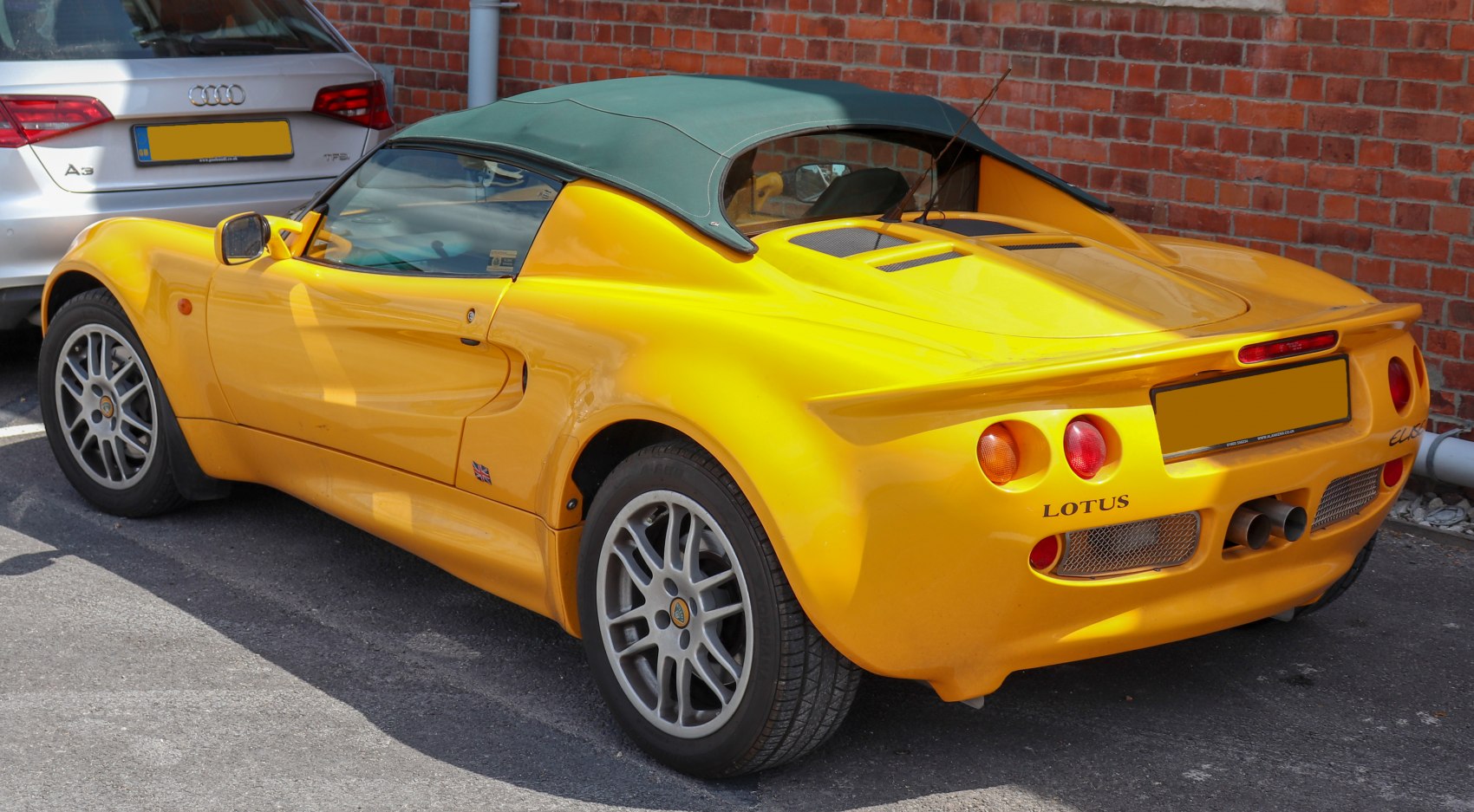 Yellow Lotus Elise Series 1 rear and side with round taillights and rear spoiler