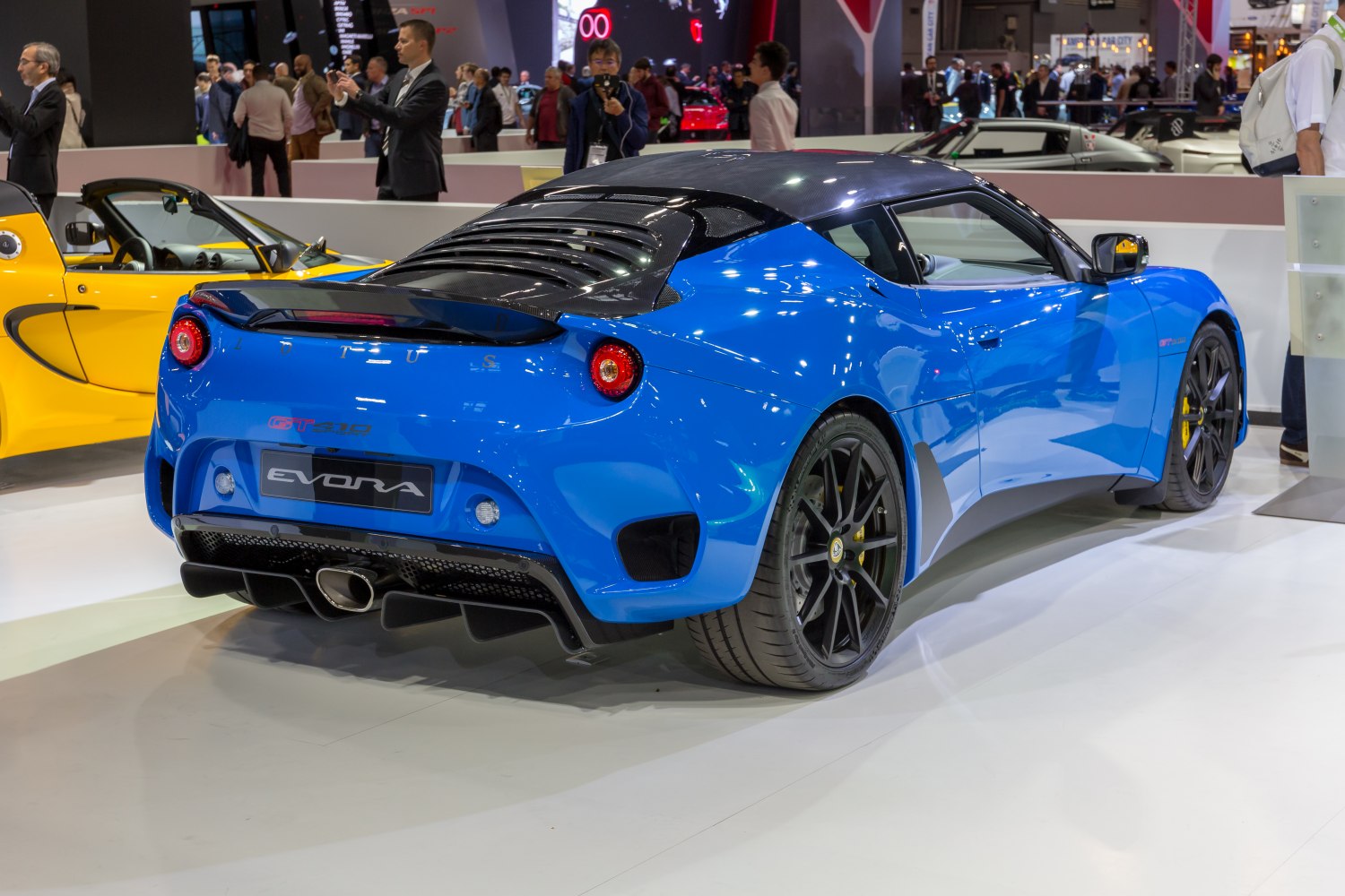 Blue sports car rear view with carbon fiber roof and diffuser