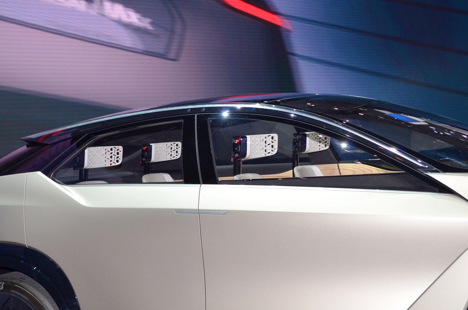 Side view of futuristic vehicle with unique geometric headrests