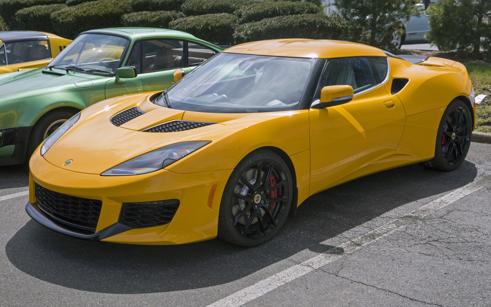 Yellow sports coupe with black alloy wheels and aerodynamic design
