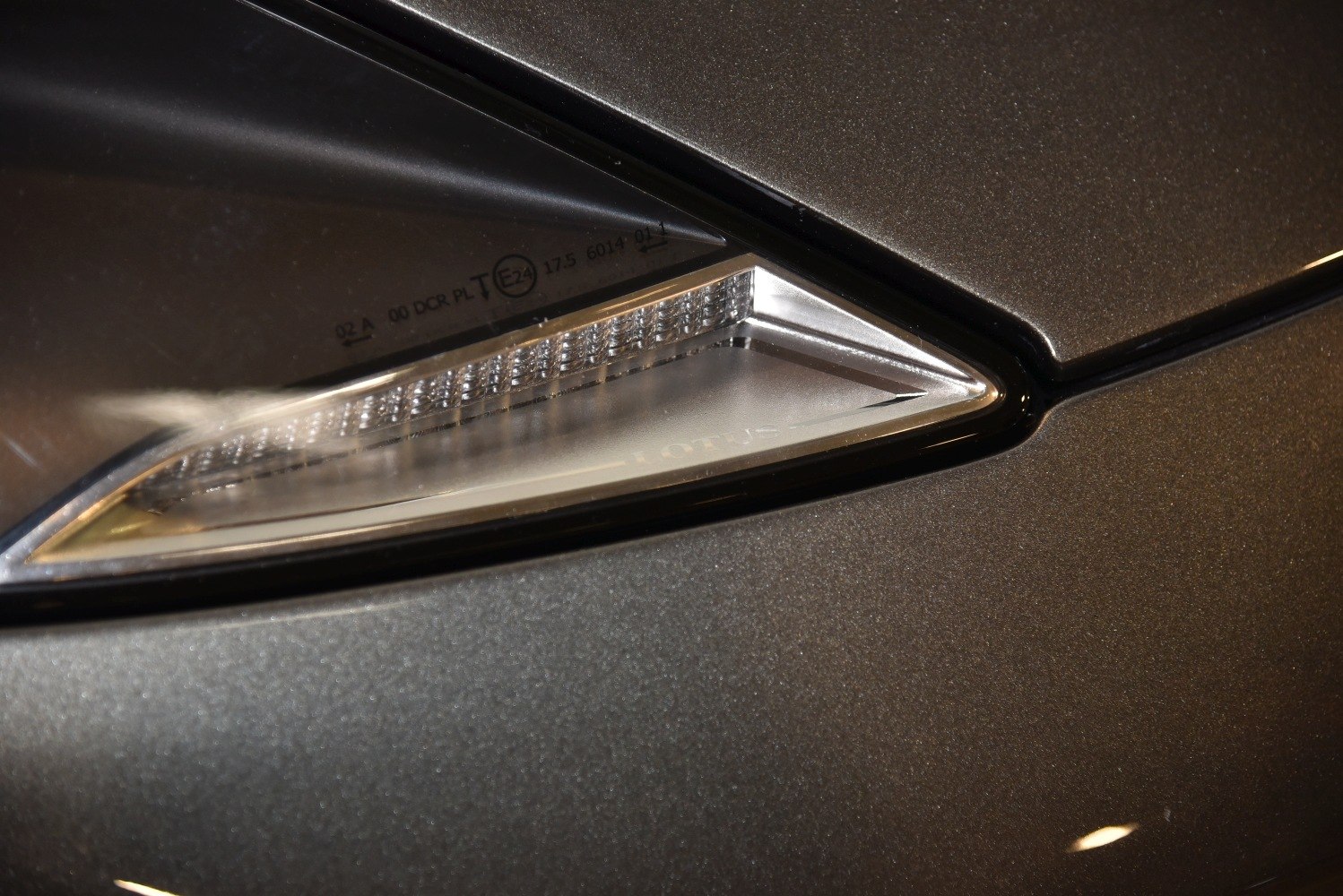 Sharp triangular side marker light on dark metallic surface