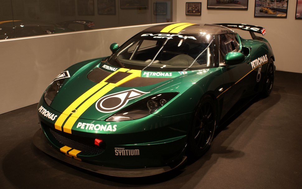 Race car with Petronas livery, aerodynamic enhancements, and large rear wing