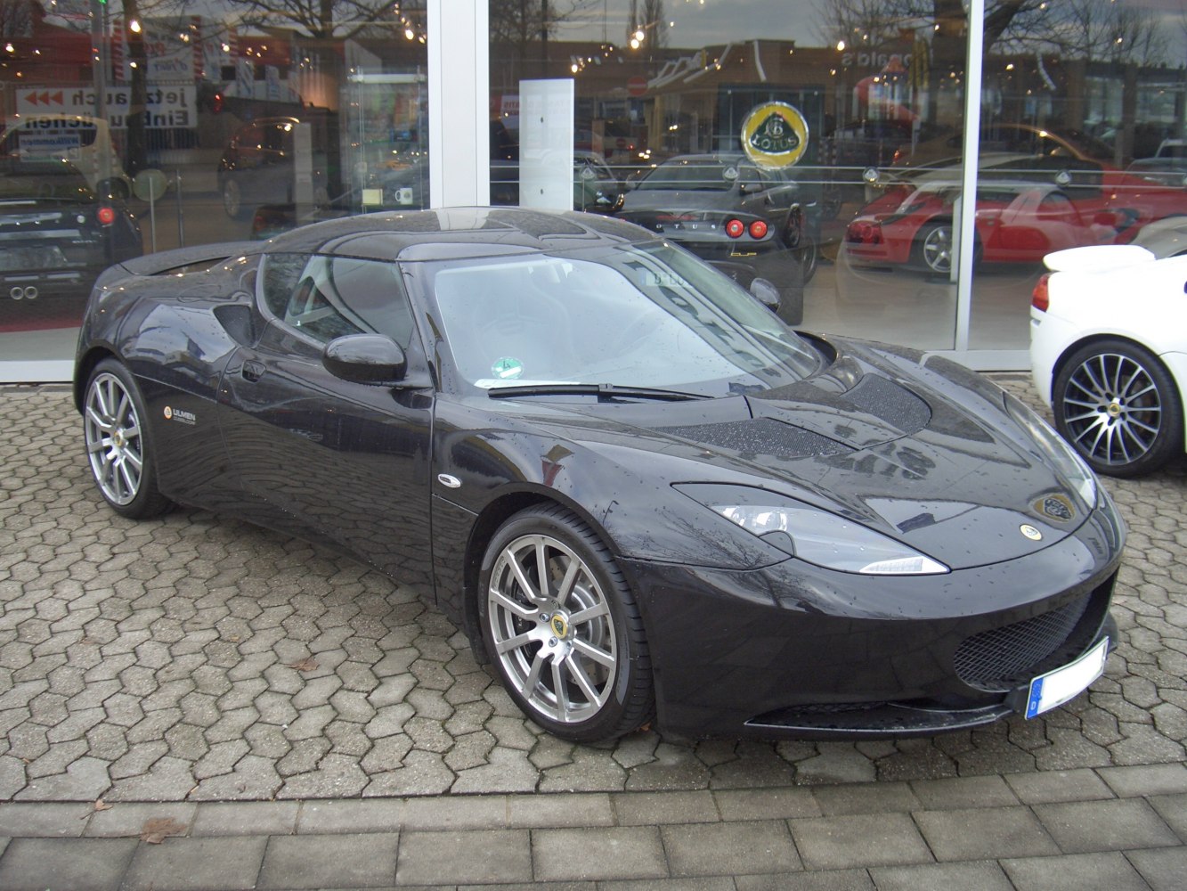 Sporty black coupe with aerodynamic front design and alloy wheels