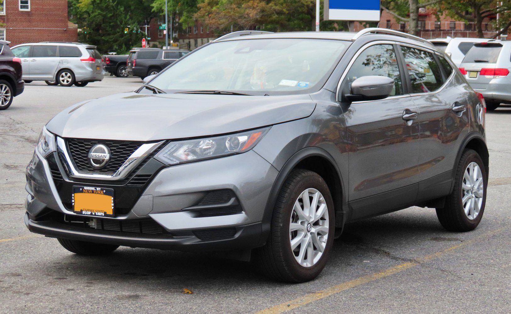 Gray compact SUV front and side view showing headlights and grille