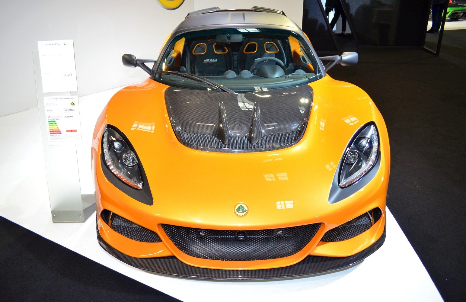 Sports car front view with carbon fiber hood and bright orange paint