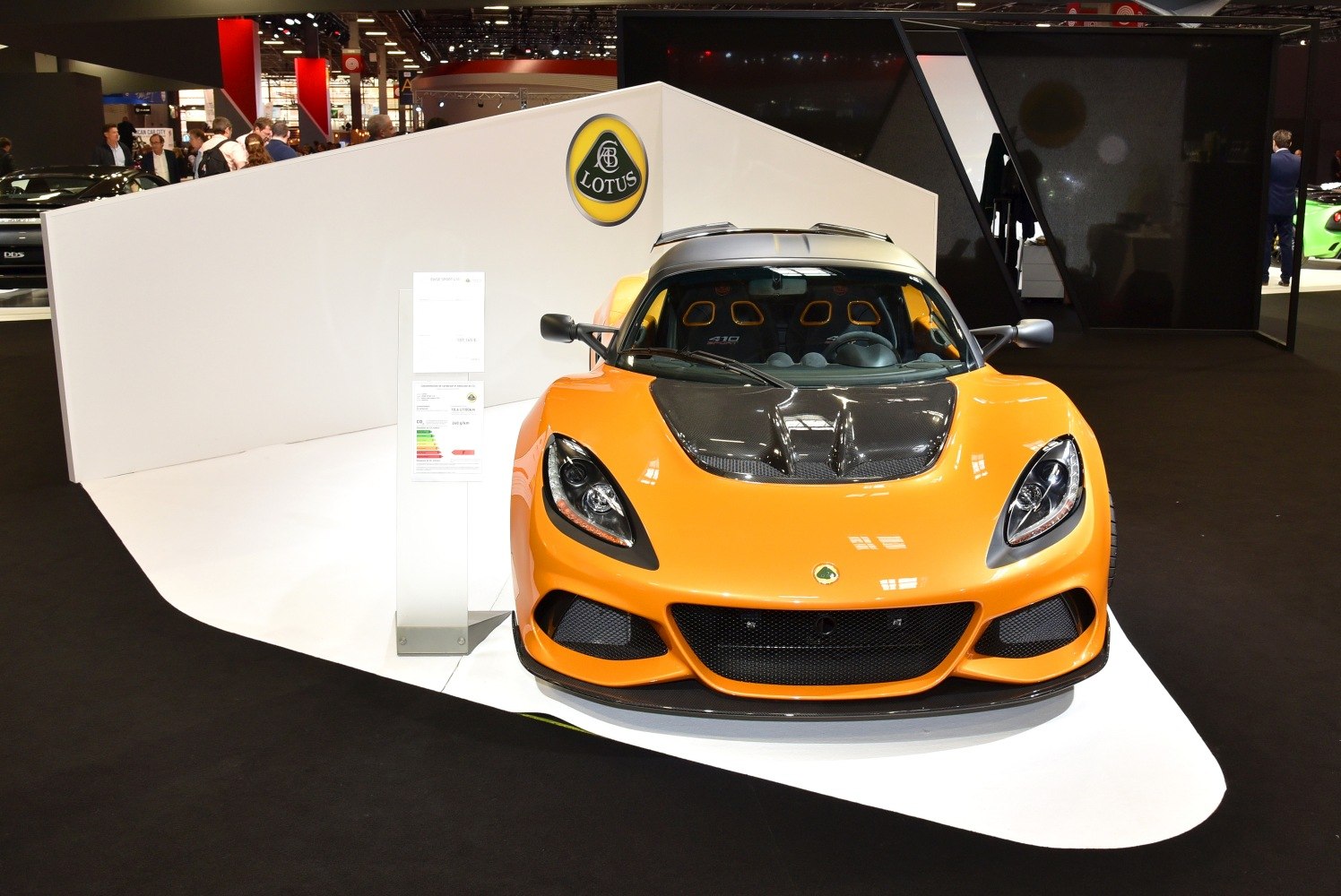 Front view of orange sports coupe with carbon fiber hood and aggressive grille