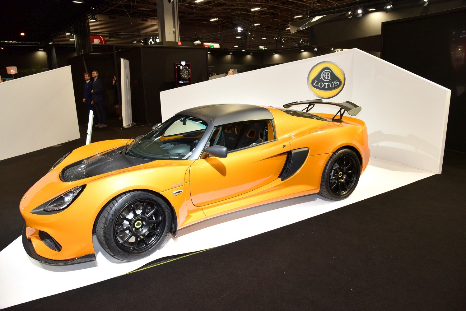 Orange sports coupe with black roof, rear spoiler, and carbon fiber accents