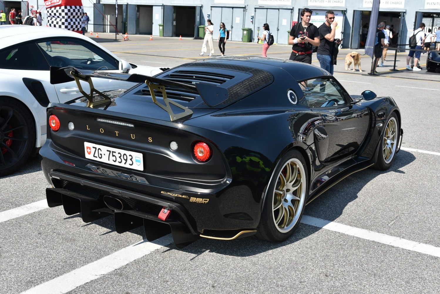 Black sports coupe with large rear wing and aggressive diffuser