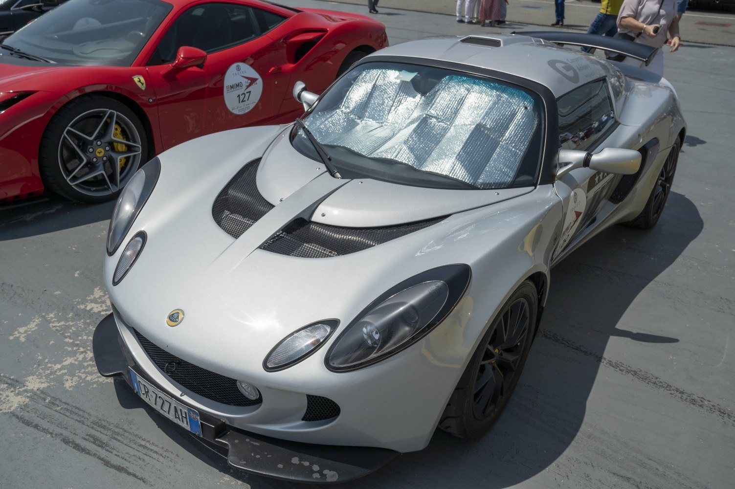 Silver lightweight sportscar with aerodynamic vents and black wheels.