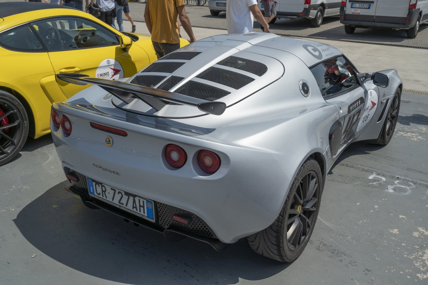 Rear view with prominent wing spoiler and vented rear deck