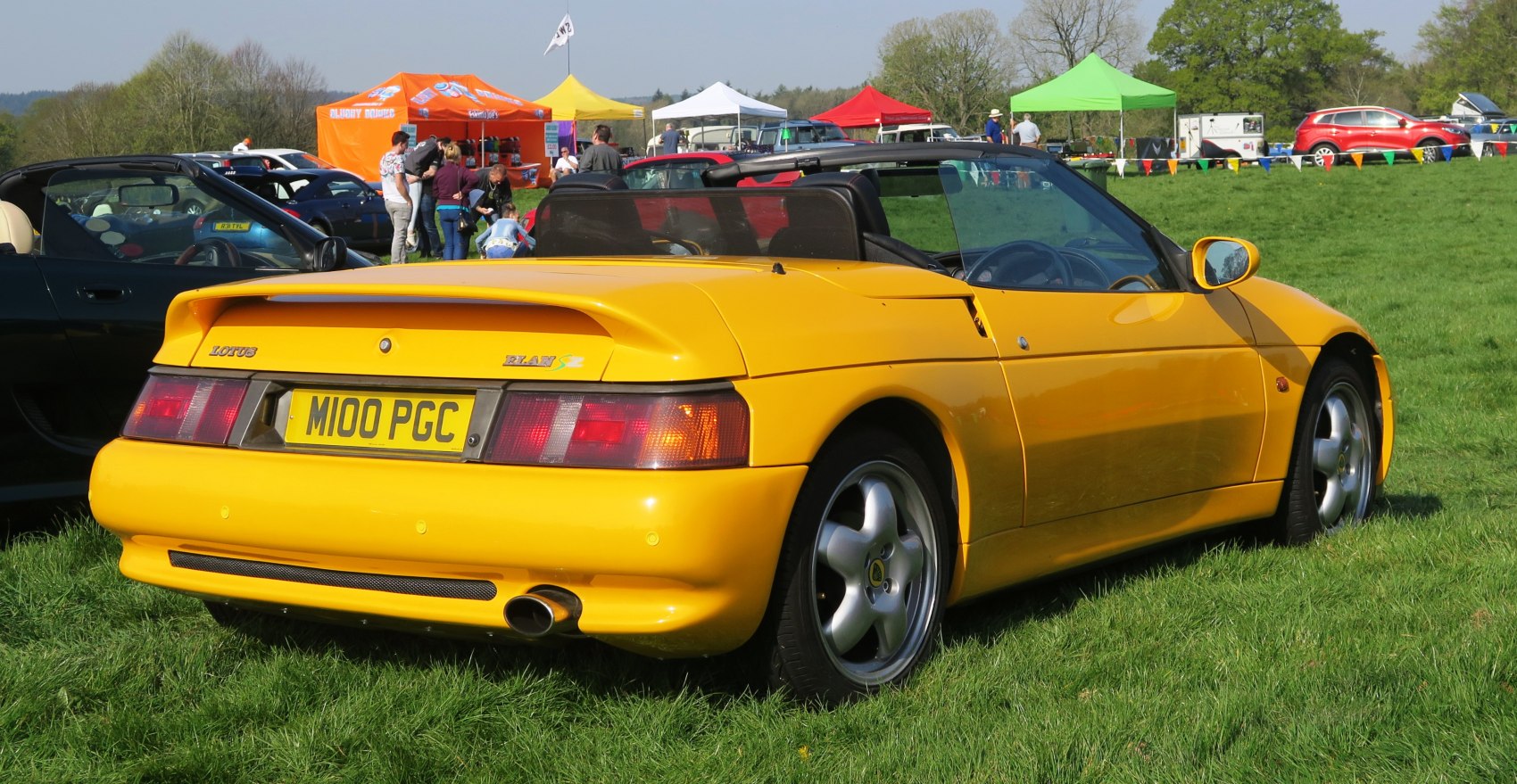 Yellow convertible with rear spoiler and alloy wheels