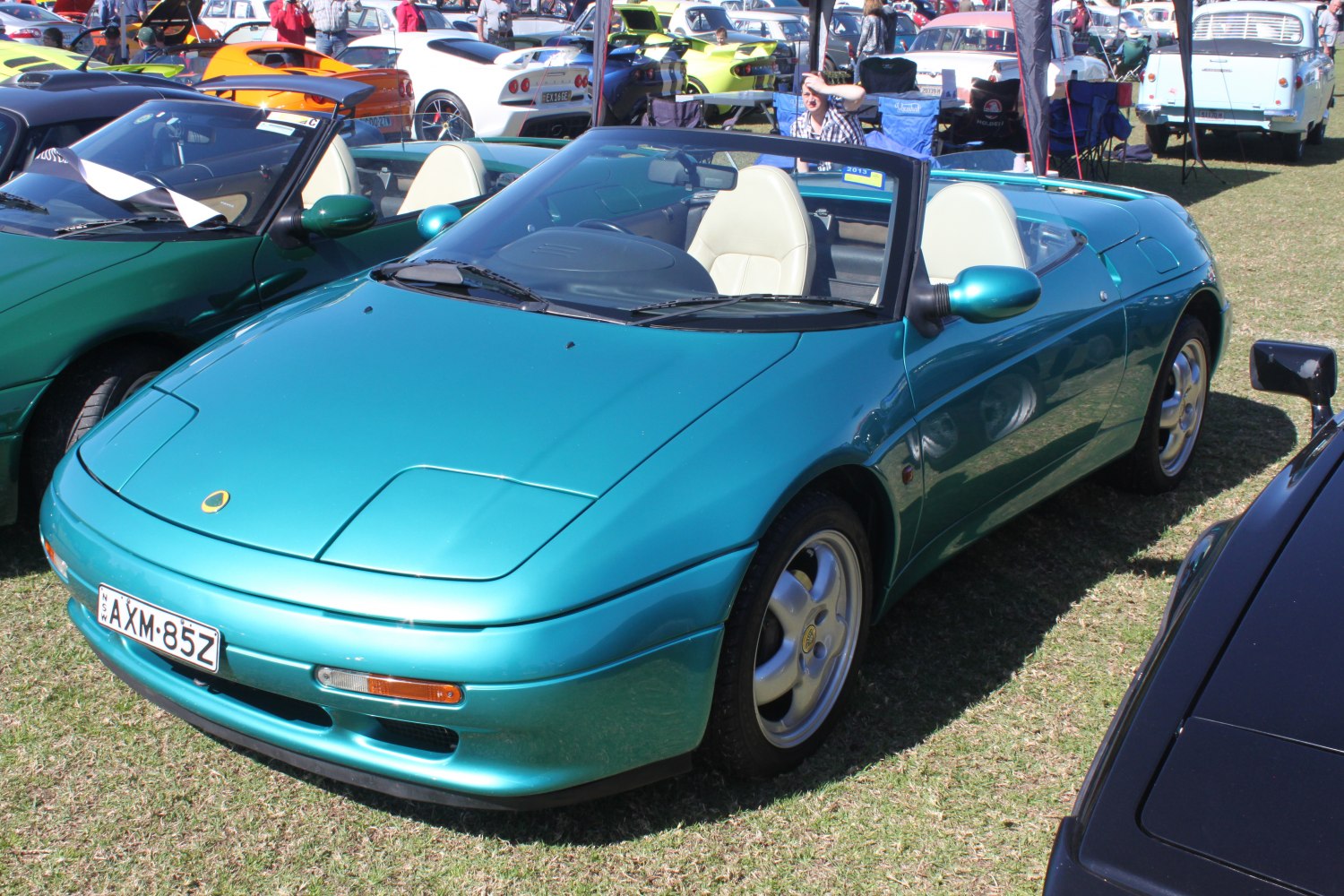 Convertible sports car with pop-up headlights and sleek rounded front design