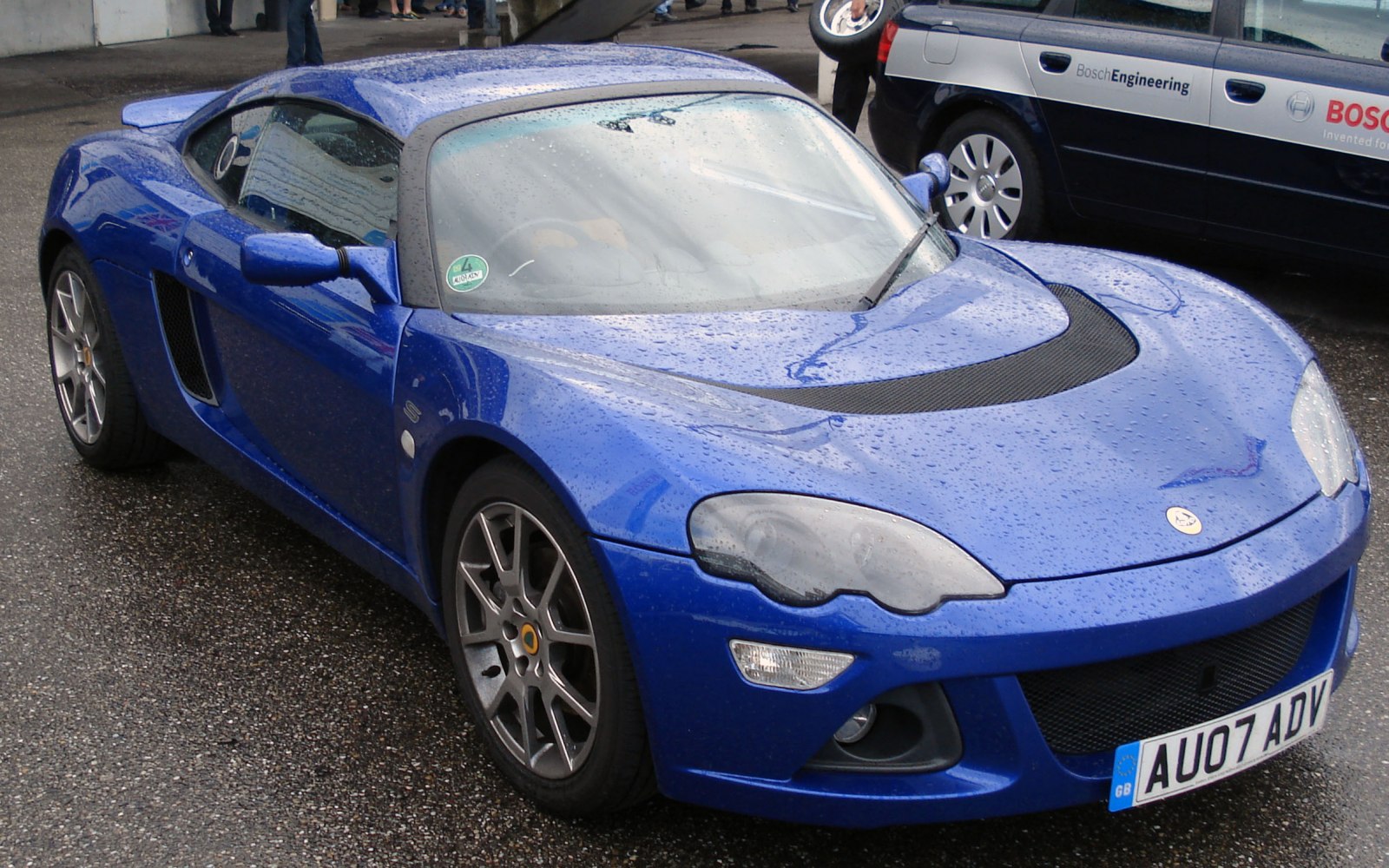 Blue sports coupe with aerodynamic design and distinctive headlights