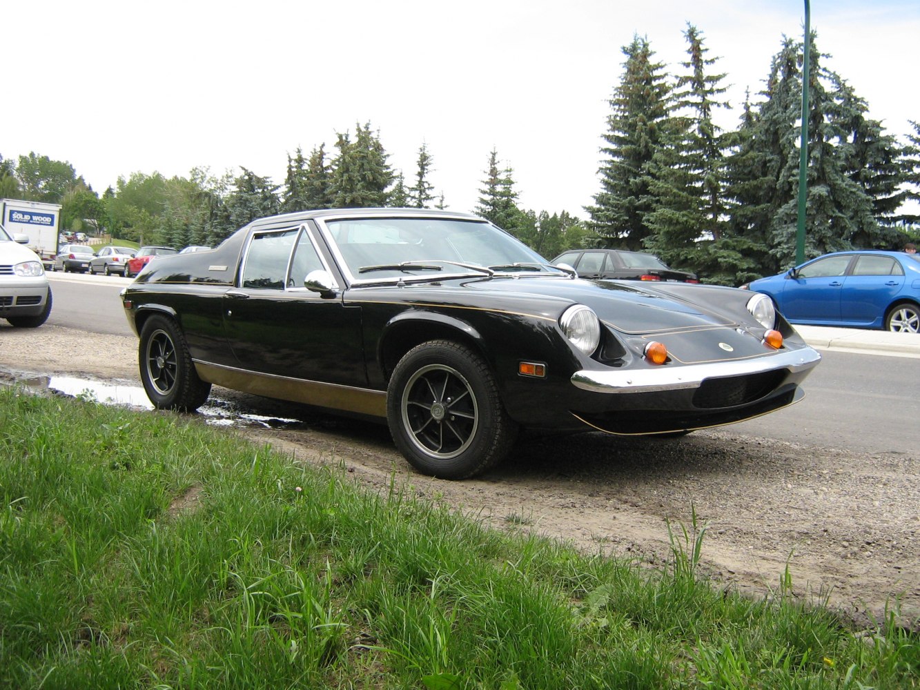 1970s sports coupe with pop-up headlights and chrome bumper