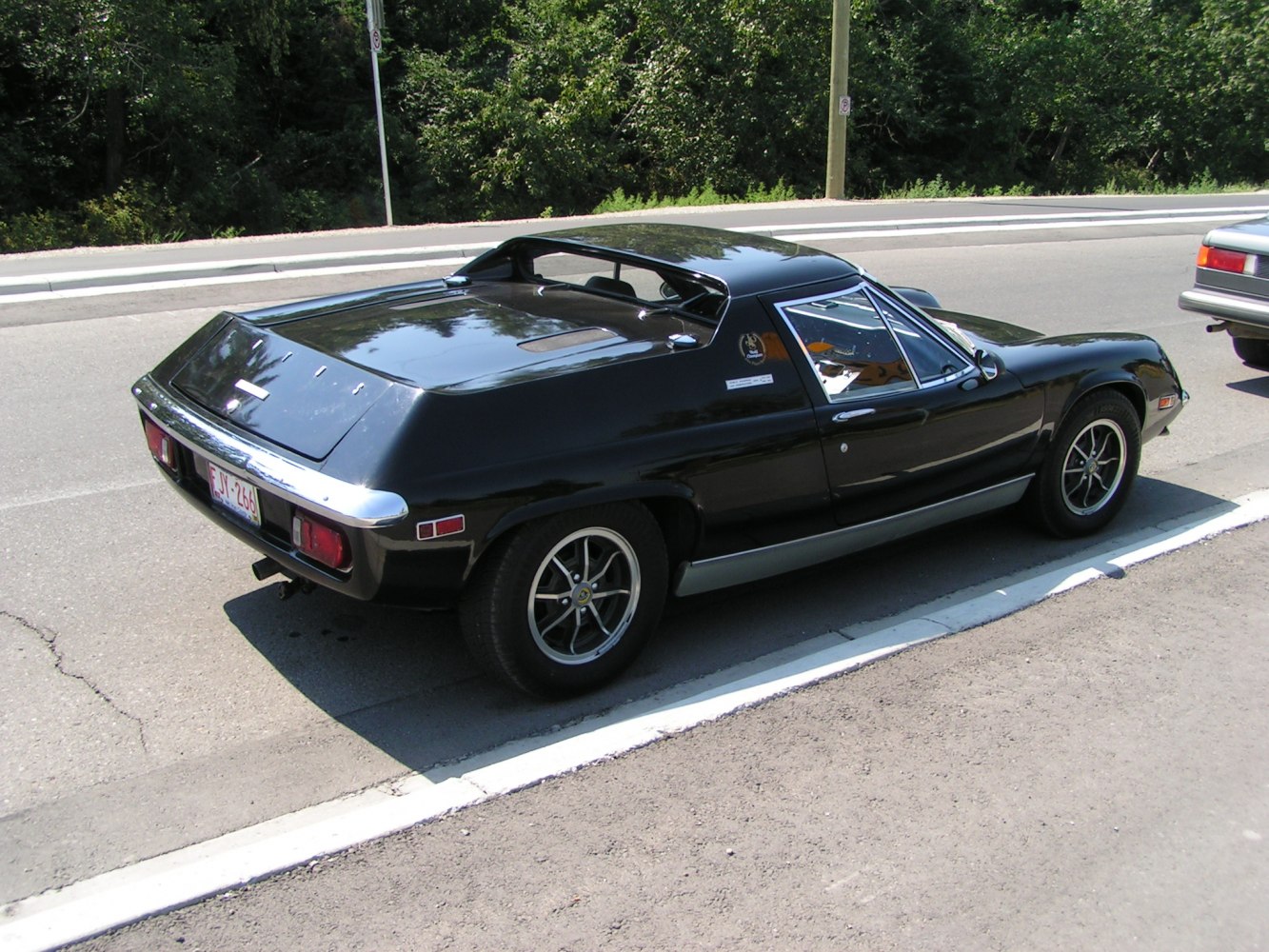 Rear side view of wedge-shaped mid-engine sports car