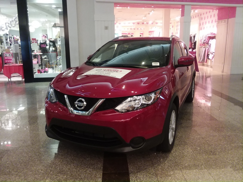 Front view of a red compact SUV with modern LED headlights and chrome grille